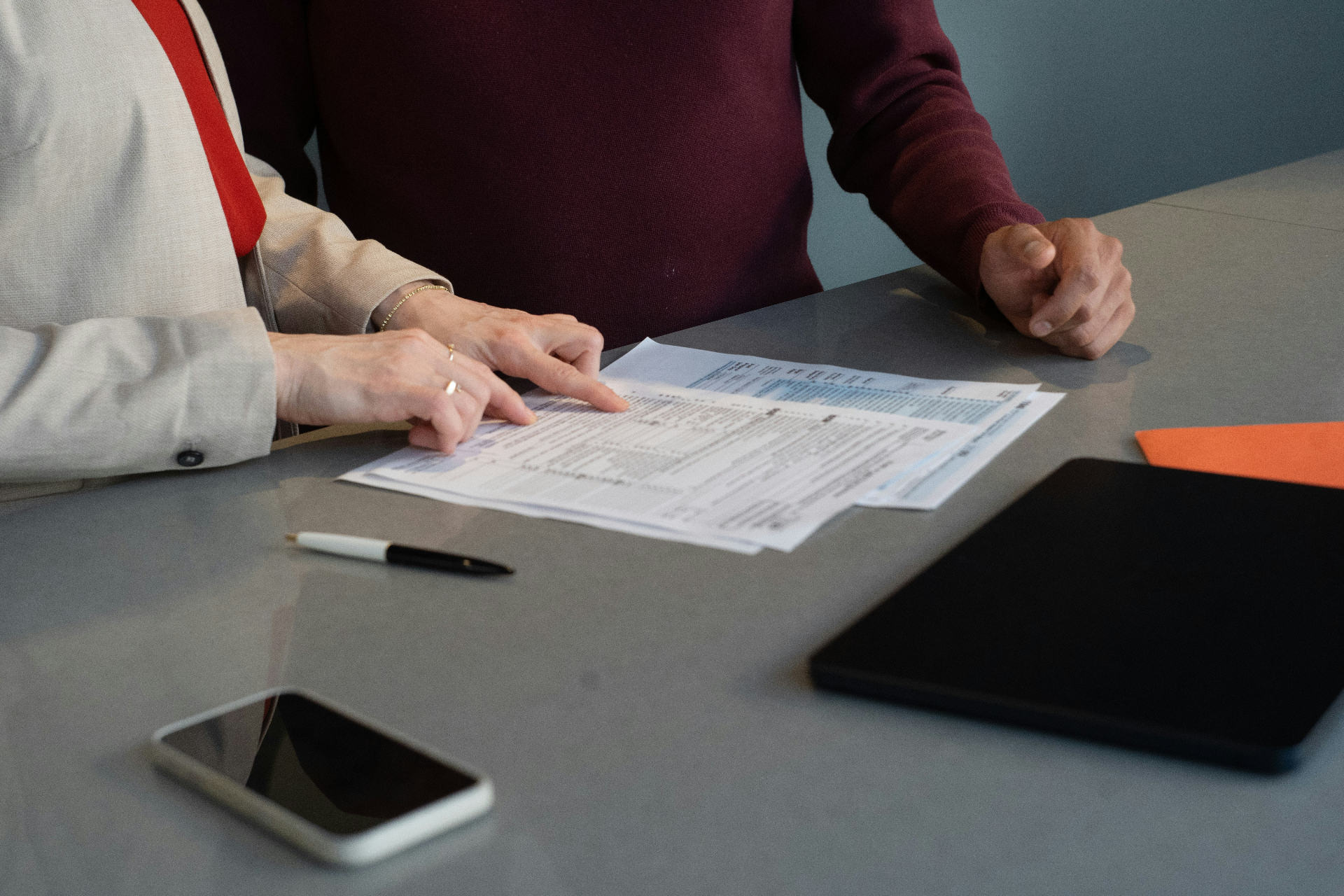 Two people reviewing documents at a desk